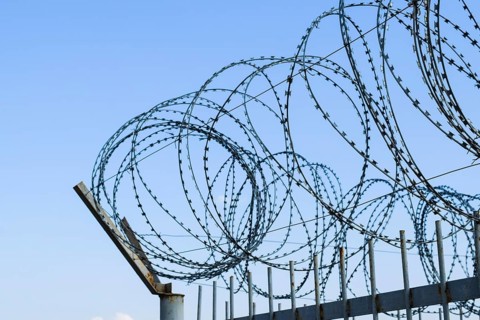 Barbed wire on the fence. Atyrau, Kazakhstan