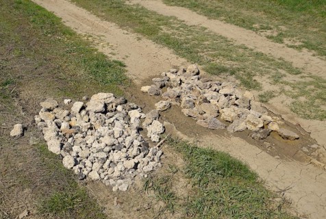 Road patching. Pits on the road are covered with stones. Atyrau, Kazakhstan