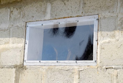 A window made of plexiglas in a concrete wall. Atyrau, Kazakhstan