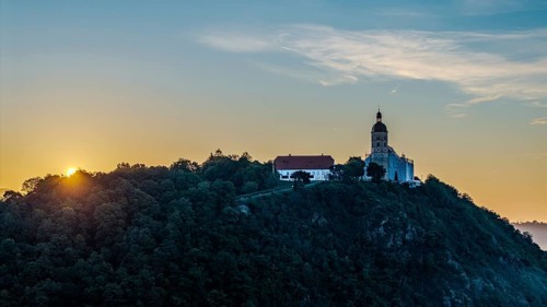 The sunrise illuminates the pilgrimage church of the Assumption of the Virgin Mary on the Bogenberg