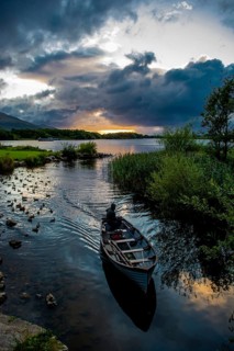 Boat returning from Lough Leane in Killarney National Park During Sunset in Ireland