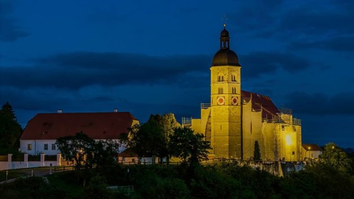 The pilgrimage church of the Assumption of the Virgin Mary on the Bogenberg has a golden light in