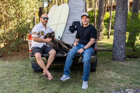 Friends and dog relaxing on a pickup truck