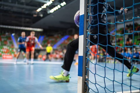 Detail of handball goal post when the ball hits it. Handball match in the background. handball.