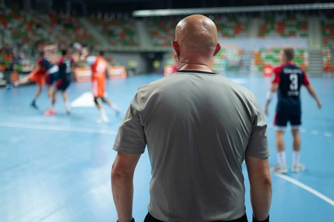 Referee's back during handball match. Lubin, Poland