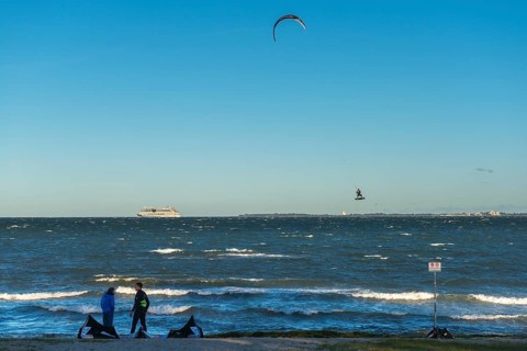 Kitesurfing in the Bay of Kiel in strong winds, high swell, Big Air Jump, Strande near Kiel,