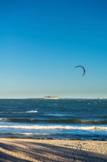 Kitesurfing in the Bay of Kiel in strong winds, high swell, Strande near Kiel,