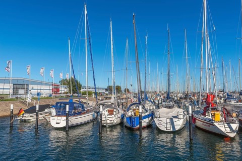 Strande marina near Kiel, Rendsburg-Eckernförde district, ship masts, water reflection, dolphins,