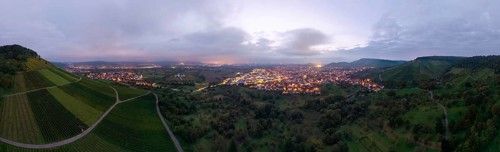 Dusk over an illuminated town, surrounded by vineyards and orchards, Korb and Kleinheppach in the