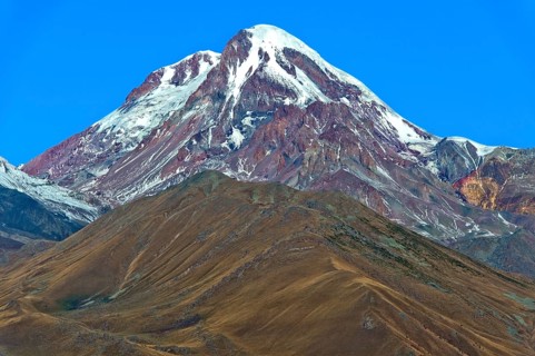 The snow and ice-covered peak of Kazbek, Stepantsminda, Georgia