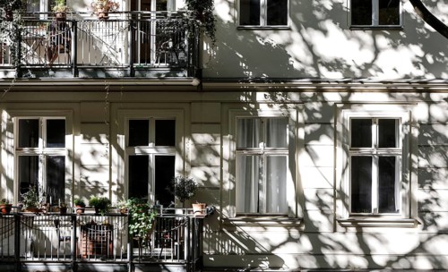 Facade of a multi-storey residential building with classical architecture with balconies with