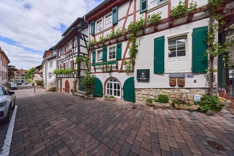 Old town, alley, historic half-timbered houses, facade with windows and shutters, cellar hatches,