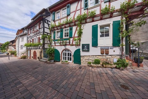 Old town, alley, historic half-timbered houses, facade with windows and shutters, cellar hatches,