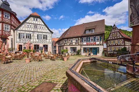 Old town, stone fountain, water, historic half-timbered houses, cobblestone square, outdoor area of