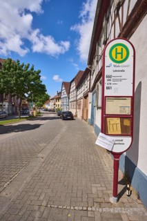 Bus stop Lehrstraße, half-timbered houses, general architecture, street, trees, car park with