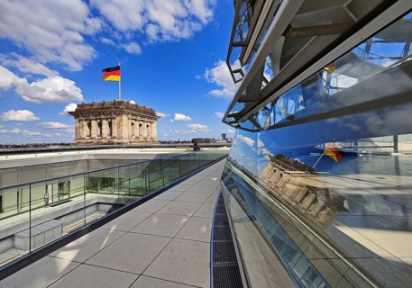 Viewing platform with a German flag in the wind on one of the corner towers and reflection in the