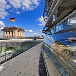 Viewing platform with a German flag in the wind on one of the corner towers and reflection in the