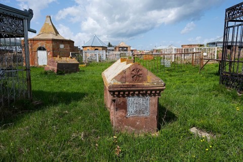 An old cemetery with decorated gravestones and inscriptions on a green meadow, Gravestone,