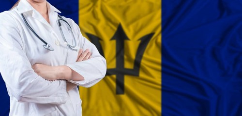 Doctor with crossed arms on Barbados flag. Barbados health and care concept. Female doctor on