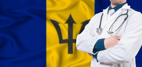 Barbados healthcare concept. Male doctor on Barbados flag. Doctor with crossed arms on Barbados