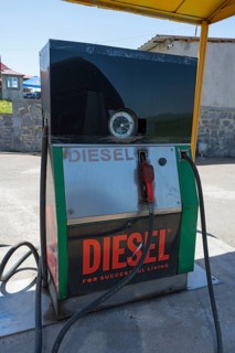 An old diesel pump at a petrol station with a large sign, diesel fuel pump, petrol station, petrol