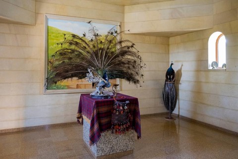 Interior view with peacock sculpture and colourful cloth on table, Yazidi temple, Yazidi temple,