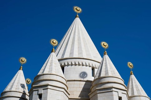 White architectural church tower with geometric shapes against a blue sky, Yazidi temple, Yazidi