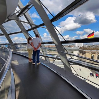 Interior view of the Reichstag dome with visitors and the German flag, Reichstag building,