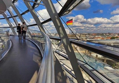 Interior view of the Reichstag dome with visitors and the German flag, Reichstag building,