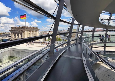 Interior view of the Reichstag dome with visitors and the German flag, Reichstag building,