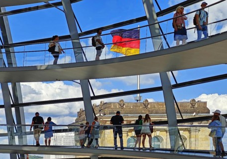 Interior view of the Reichstag dome with visitors on the ramps and the German flag, Reichstag