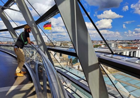 Interior view of the Reichstag dome with visitors and the German flag, Reichstag building,