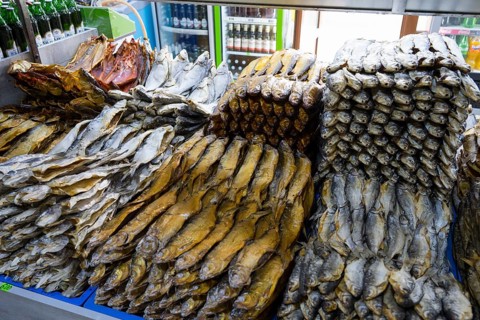 Stacks of fish in different patterns and heights on a market display shelf, fish sale, Tsovagyugh,