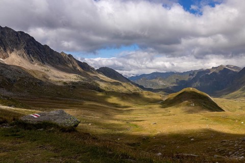 Alpe Carorescio with Piano Grande plateau and hiking trail marker, Quinto, Ticino, Switzerland