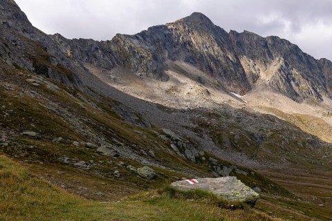 Hiking trail marker at Passo del Sole with Bassa di Pos Lei, Quinto, Ticino, Switzerland