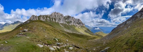 View from Passo del Sole towards Blenio Valley and Lukmanier, on the left steep rock faces at