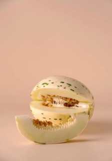 Hybrid honeydew melon on a beige background