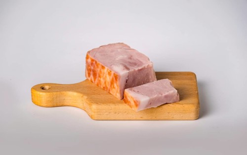 Smoked bacon on wooden board, copy space