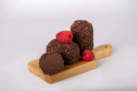 Cocoa and raspberry cake on a board, copy space
