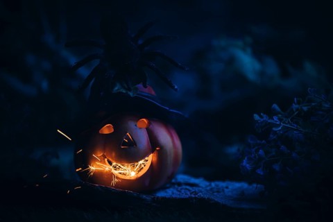 Glowing pumpkin with spider and sparks, dark, spooky, Halloween