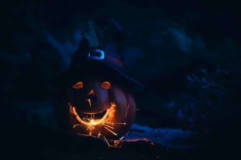 Glowing pumpkin with sparks in the dark, Halloween