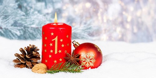 First 1st Advent candle for Christmas Christmas card in winter with text free space Copyspace