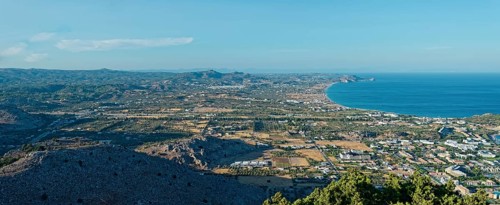 Expansive coastal landscape of Kolymbia and Faliraki, with mountain ranges and coastline under a