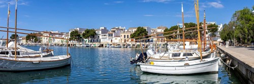 Portocolom fishing village on Majorca panorama with boats and colourful houses holiday by the sea
