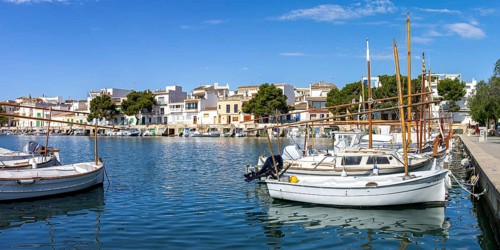 Portocolom fishing village on Majorca with boats and colourful houses Holiday by the sea Panorama