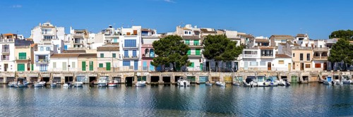Colourful houses in Portocolom Fishing village on Majorca with boats Holiday by the sea Panorama