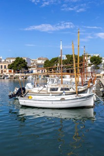 Portocolom fishing village on Majorca with boats and colourful houses Holiday by the sea in