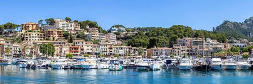 Port de Soller town on Majorca holiday by the sea yacht harbour with boats panoramic trip in Port