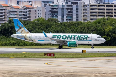 A Frontier Airlines Airbus A320 aircraft with the registration number N233FR at San Juan Airport,