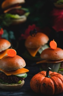 Small burgers with pumpkin in an autumnal, spooky atmosphere